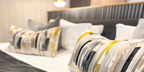 a row of pillows sitting on top of a bed at Beech Hill Hotel & Spa in Windermere