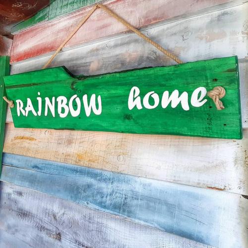a green sign that says rainbow home on a wall at RAINBOW HOME in Gornji Štoj