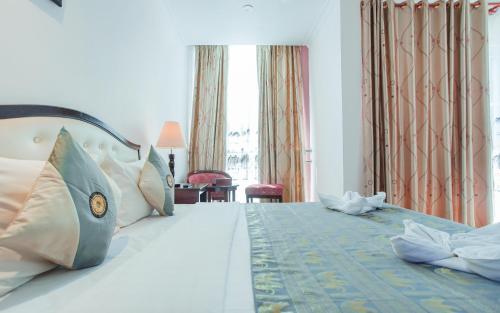 a hotel room with a large bed with pillows at Silver Mounts Hotel in Phnom Penh