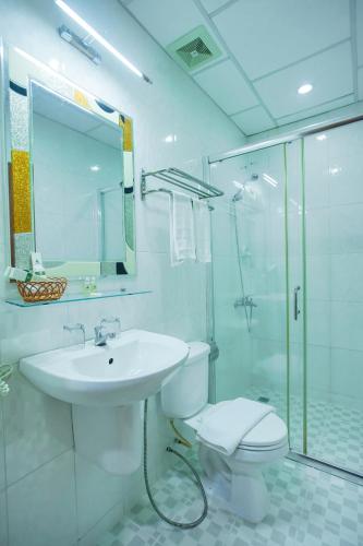 a bathroom with a toilet and a sink and a shower at Silver Mounts Hotel in Phnom Penh