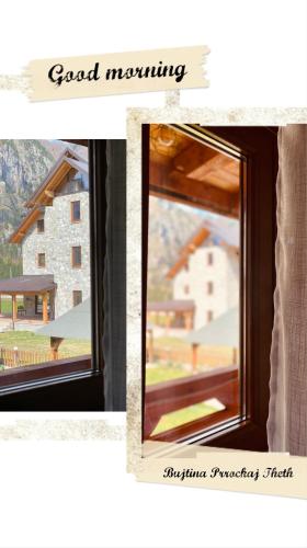 a window with a view of a house at Guesthouse Prrockaj Theth in Theth
