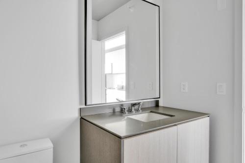 a bathroom with a sink and a mirror at S Loop Studio w Pool Gym Spa nr Grant Park CHI-739 in Chicago