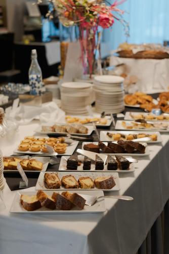 a table with many different types of food on it at Cosmopolitan Hotel in Civitanova Marche