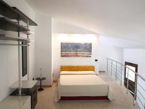 a bedroom with two beds and a painting on the wall at Domus Open Space in San Donato di Lecce