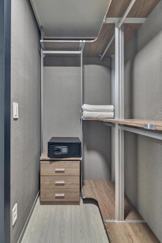 a room with a bunk bed with a desk at Gangneung Chonpines Ocean Suites Hotel in Gangneung