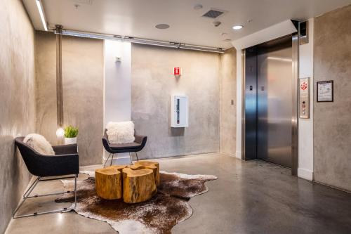 Un vestíbulo con una mesa de café y sillas hechas con un tocón de árbol. en Redwood City 1br w gym lounge wd nr Caltrain SFO-1232, en Redwood City