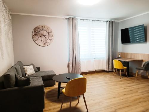 a living room with a couch and a table at Pokoje gościnne Jola in Drawsko Pomorskie