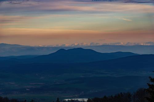 a view of a mountain range at sunset at Larix Mátra Vendégház in Matraszentlaszlo