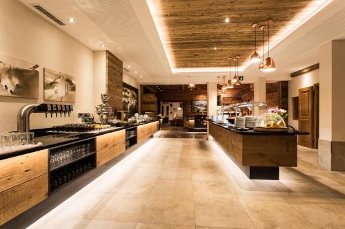 a large kitchen with a large island in a room at Hotel Weisseespitze in Kaunertal