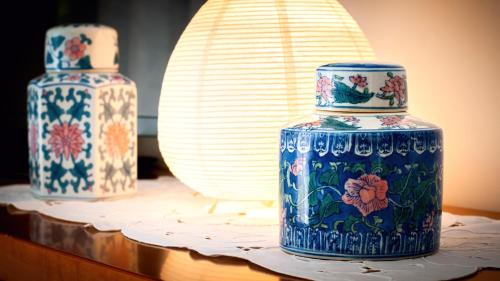 two blue and white vases sitting on a table at La casa di Bianca - Casa Vacanze in Villa Opicina