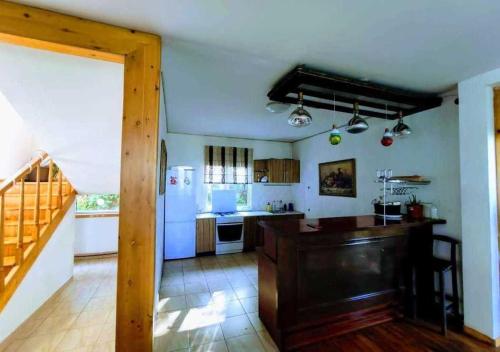 a large kitchen with a white refrigerator and a table at Panorama Hills in Almaty