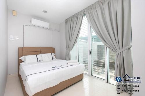 a bedroom with a large bed and a large window at GeorgeTown 6BR KTV Bungalow 28Pax in George Town