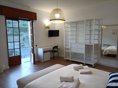 a bedroom with a bed and a desk and a room at Casa Teranga in Furore