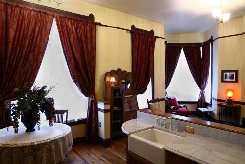 una cucina con lavandino e tavolo in una stanza di Martin & Mason Hotel a Deadwood