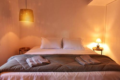 a bedroom with a bed with two towels on it at Villa Pont Bleu in Canacona