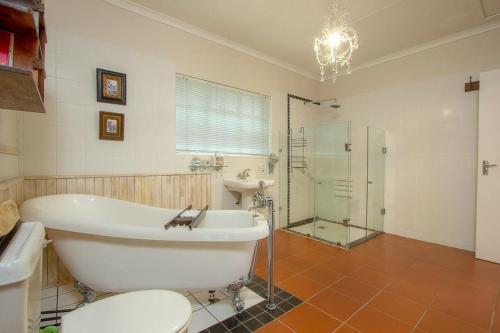a bathroom with a tub and a shower and a sink at Kruger Allo View B&B in Komatipoort
