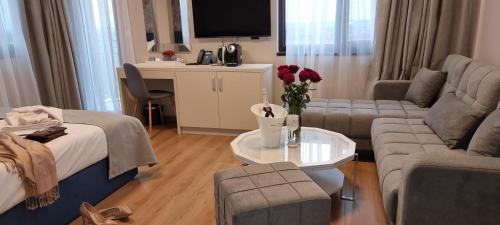 a living room with a bed and a couch and a table at Park Hotel Viasport in Gorni Dŭbnik