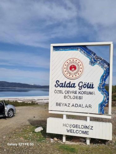 a sign in front of a body of water at Salda Gölüne çok yakın in Yeşilova