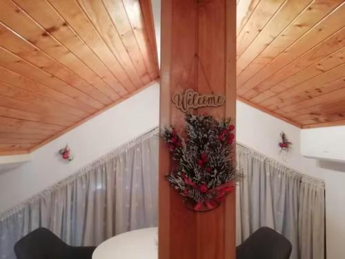 a dining room with a table with a christmas wreath at Green Loft Apartment-Rose in Sliven