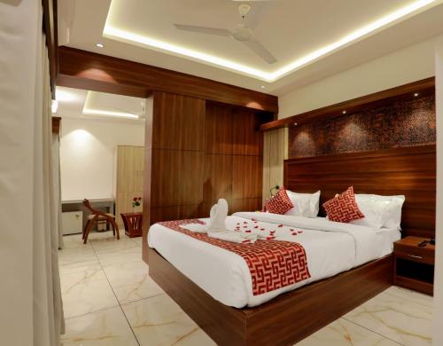 a bedroom with a large bed in a room at Hotel Vrindavan in Wayanad