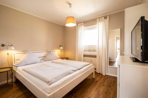 Postel nebo postele na pokoji v ubytování Haus Nordseeblick Wohnung 32