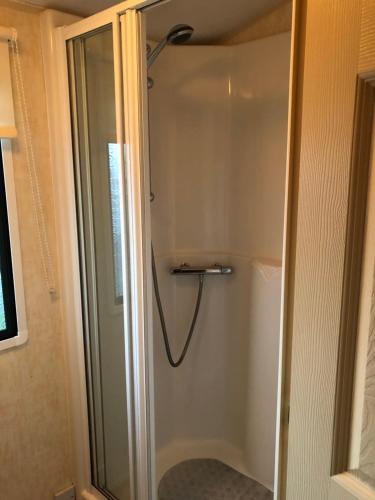a shower with a glass door in a bathroom at Sws Coral Beach 3 bedroom sleeps 6 in Ingoldmells