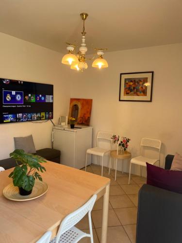 a living room with a table and chairs at Individual house free parking wifi Netflix Disney next to EPFL Lausanne in Ecublens