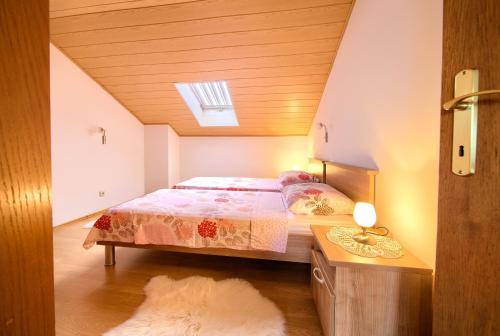 a bedroom with a bed and a skylight at Apartment Mladen in Krk