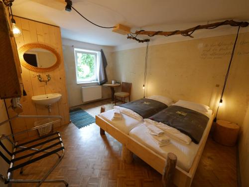 a bedroom with a bed and a bathroom with a sink at The Keep Eco Rooms in Salzburg