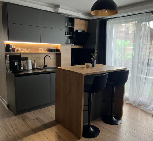 a kitchen with a island in the middle of a room at Tessa Apartment in Floreşti