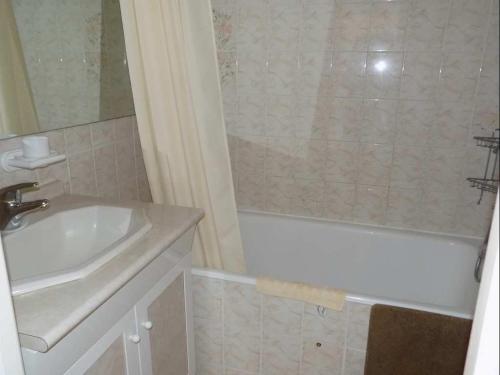 a bathroom with a sink and a tub and a shower at 5006 Port Brescou 310 in Cap d'Agde