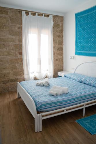a bedroom with a bed with towels on it at La Terrazza sui Bastioni in Alghero