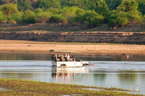 a group of people in a boat in the water at Msandile River Lodge in Kakumbi