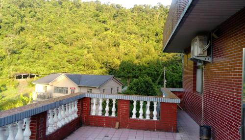 a balcony of a house with a view of a mountain at Song Lin Homestay in Dongshan