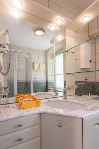 a bathroom with a sink and a mirror at Apartments Kalalarga Deluxe- city centre&balcony in Makarska