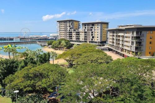a view of a city with buildings and a beach at ZenLux: 4BR Bayview Mansion Infinity Pool + Cinema in Stuart Park