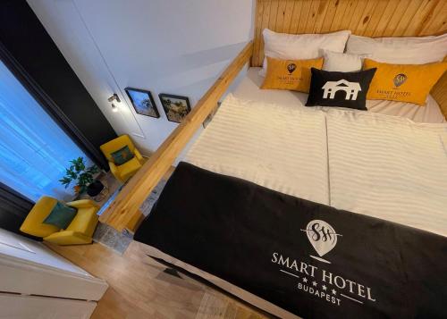 a large bed in a small hotel room at Smart Hotel Budapest in Budapest