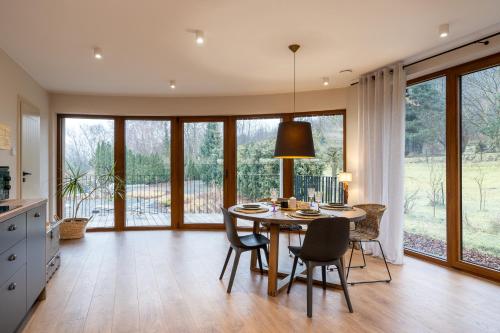 a kitchen and dining room with a table and chairs at ZaKa Apartments in Kraków