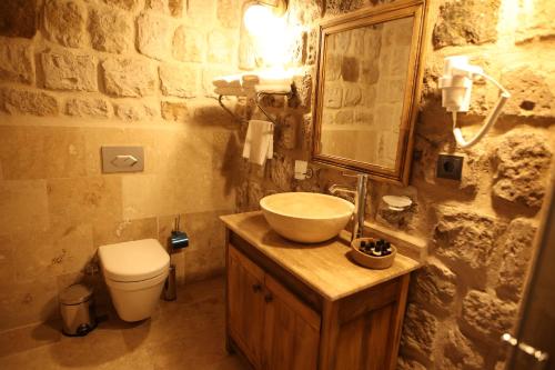 a bathroom with a sink and a toilet at Cappadocia Vita Cave Hotel in Urgup