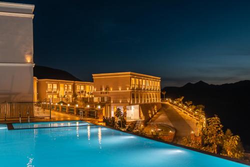 a resort with a swimming pool at night at Tree of Life Vantara Resort & Spa in Udaipur