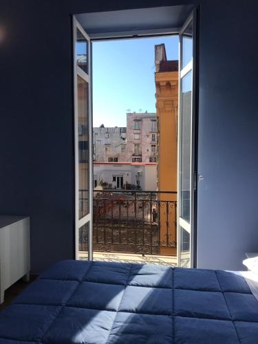 a bedroom with a bed and a view of a balcony at B&B I Due Teatri in Naples