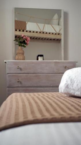 a bed with a dresser in a bedroom at Stavros Residence in Mármara