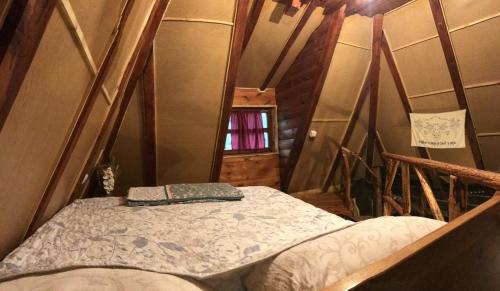 a small room with a bed in a house at Chalet Etno Oaza near Airport in Sarajevo