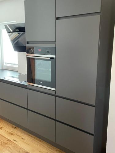 a kitchen with a refrigerator and a microwave at City house with garden, free parking in Graz