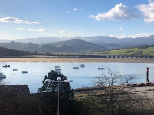 a view of a river with boats on it at Vistas de La Barquera in San Vicente de la Barquera