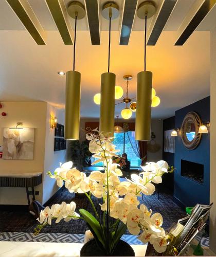 a chandelier with white flowers in a living room at The Continental Hotel, Derby in Derby