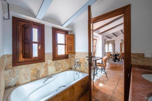 a bath tub in a room with a table at Casa Daci in Altea