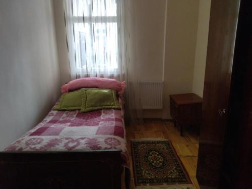 a small bedroom with a bed and a window at Apartment for good feelings in Sevan