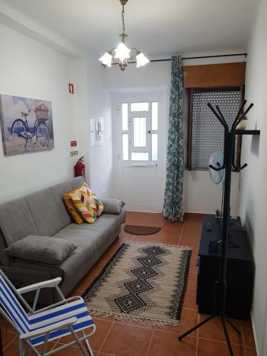a living room with a couch and a chair at Moradia Rocleo Tavira House in Tavira