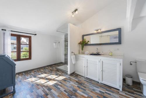 a bathroom with a sink and a toilet at Es Garroverar in Pollença